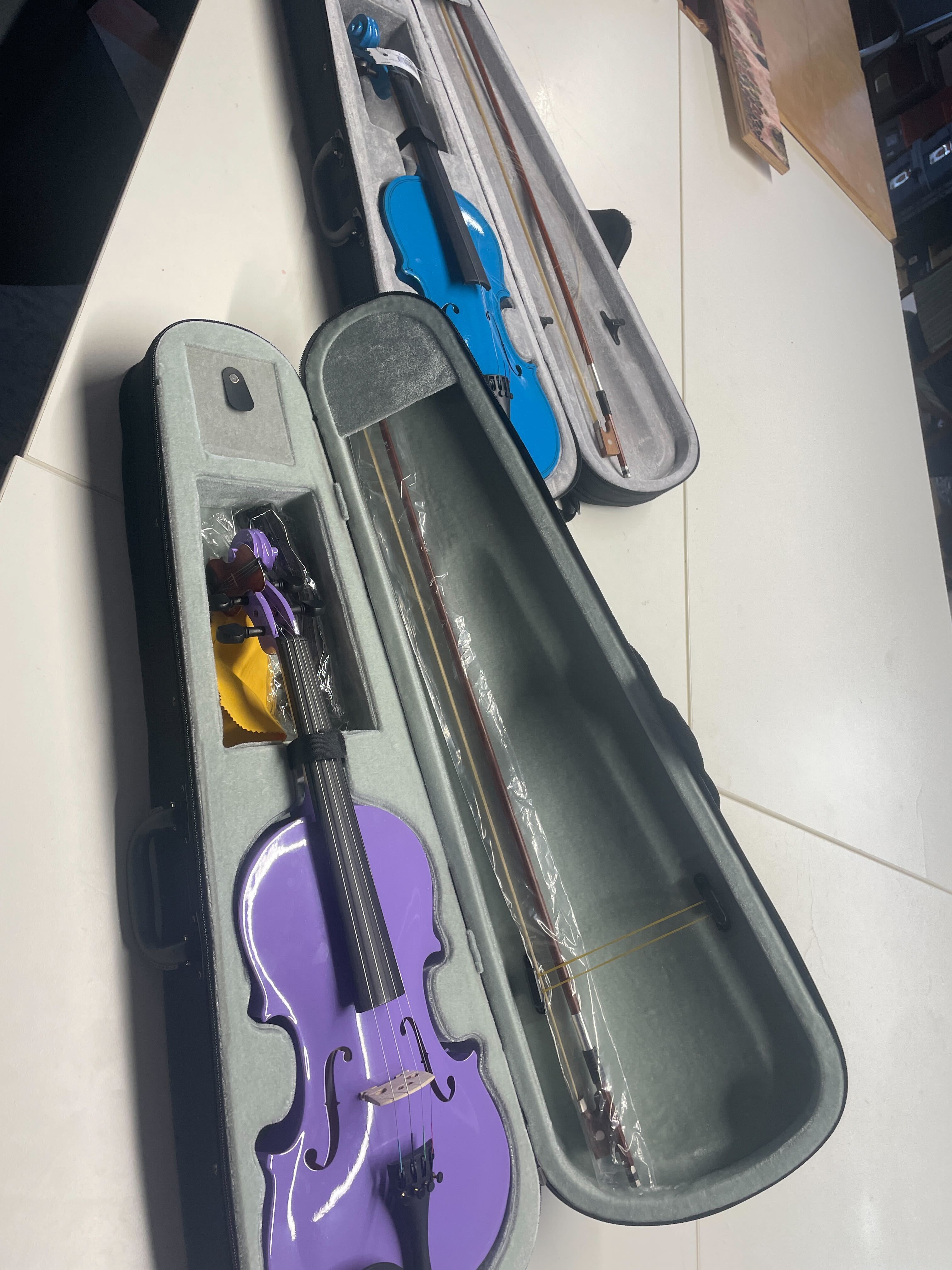 The two donated violins, purple and blue
