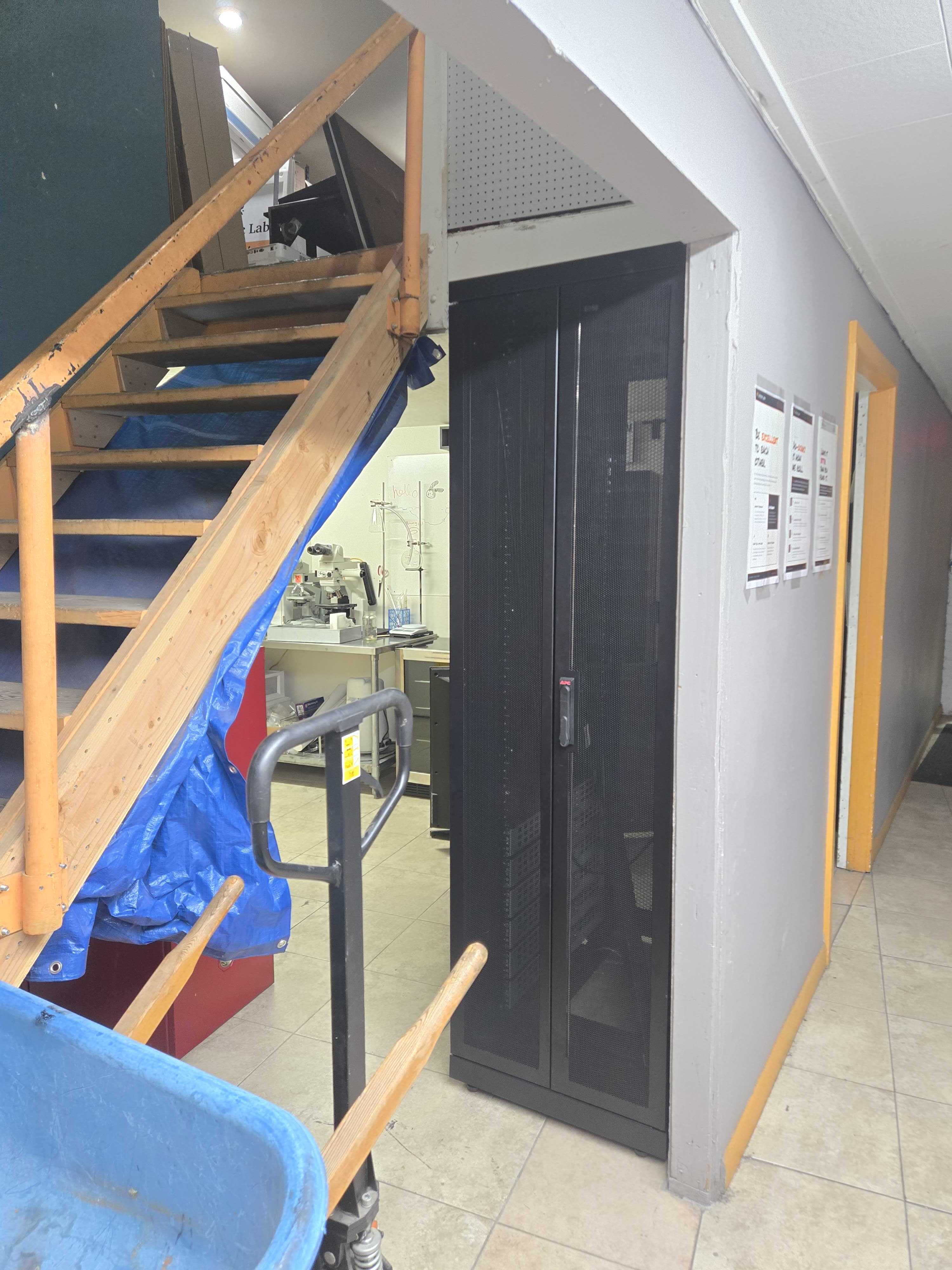 Server rack tucked under the stairs